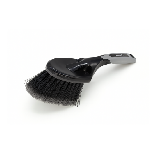 Black brush with a handle on a white background